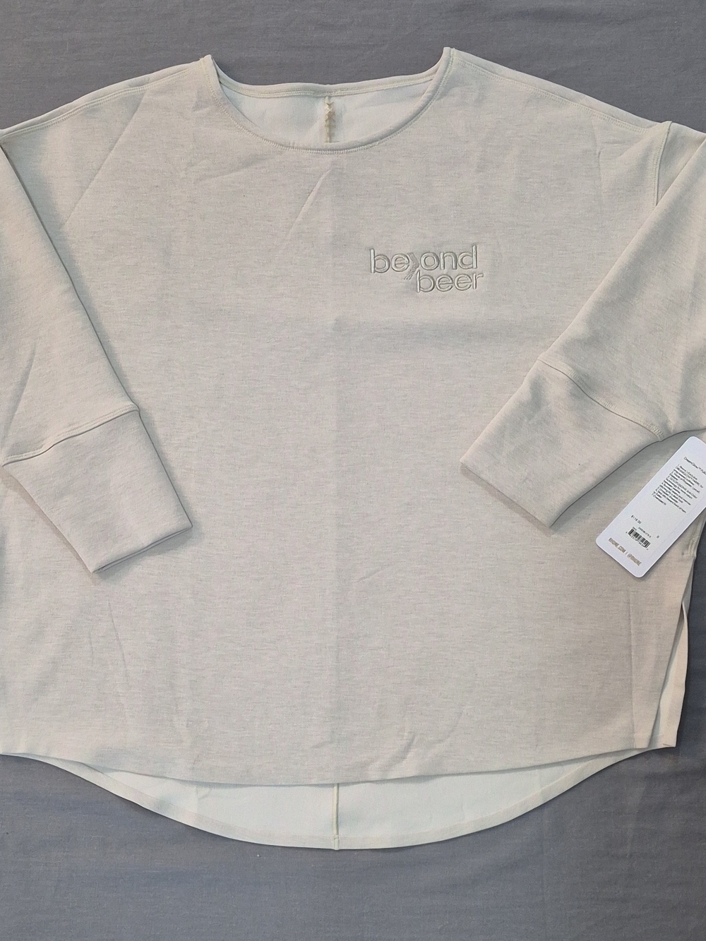 RHONE Light Beige Crewneck Top with Subtle Gold Logo